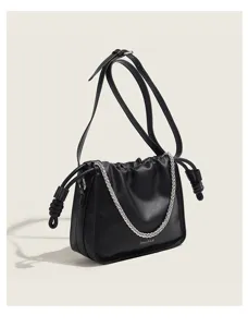 Detail shot of the black stylish shoulder bag featuring gathered design and metal chain.