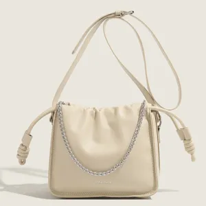Stylish beige leather shoulder bag with chain and gathered design, front view main image.