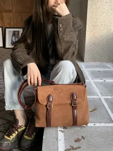 Vintage brown suede messenger bag for women, retro crossbody shoulder bag with double buckles.