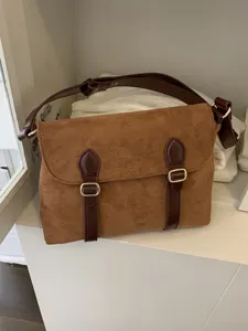 Retro brown suede messenger bag with dark brown leather straps and classic metallic buckles.