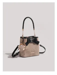 Vintage style bucket bag for women, chic bow knot design with top handle and cute plush charm.
