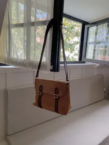 Vintage suede messenger bag for women, retro brown shoulder crossbody bag with dual buckles.
