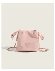 Pink cloud bucket bag detail, soft leather material with gold chain strap, chic and stylish design.