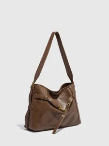 Brown leather shoulder bag, stylish commuter handbag with metal buckle detail and strap accent.