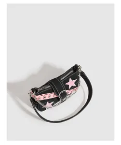 Detailed view of black Y2K shoulder baguette bag with pink stars and metal chain accents.