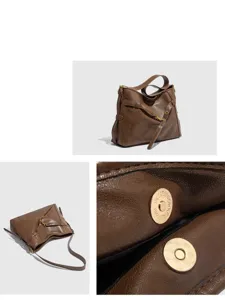 Detail view of brown leather shoulder tote bag, showing premium texture, hardware and clasp.