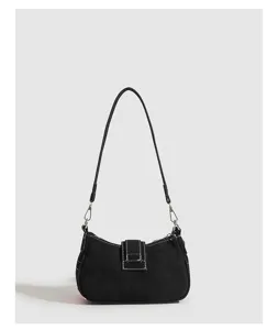 Y2K black shoulder bag for women, trendy baguette handbag with contrast stitching and strap.