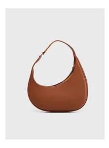 Brown crescent leather hobo bag detail shot, minimalist curve underarm style accessory.