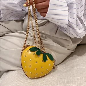 Cute yellow strawberry design shoulder bag with golden chain for daily fashion.
