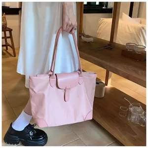 Pink tote bag detail showing large capacity, leather flap closure and comfortable shoulder handles.