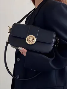 Detailed view of black leather baguette shoulder bag featuring luxury gold hardware accent.