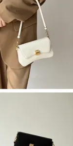 Chic urban minimalist underarm baguette shoulder bag for women, elegant daily fashion accessory.