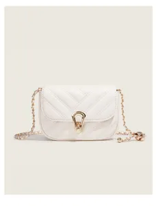 White quilted crossbody bag detail, elegant gold chain strap with chic clasp closure.