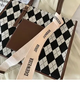 Black and white argyle commuter tote bag detail showing premium fabric texture and strap.