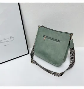 Green shoulder bucket bag for women with stylish leopard print wide strap and ample capacity.