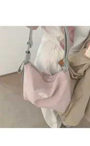 Pink canvas underarm shoulder bag with grey bow strap, casual stylish daily tote accessory.