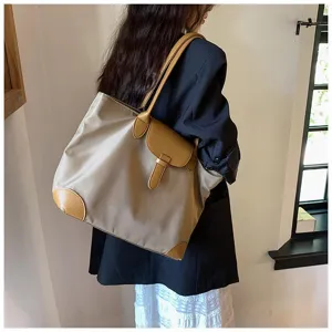 Women's large capacity tote bag, commuter shoulder bag with contrast leather flap and corner design.
