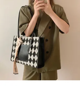 Stylish black and white argyle commuter tote bag with ribbon detail for modern women.