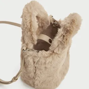 Chic faux fur bucket bag for women, trendy plush shoulder crossbody bag with strap.