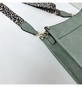 Green shoulder bag detail view, leopard print wide strap, gold hardware, elegant style.