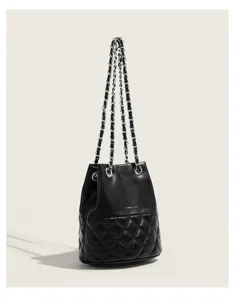 Black quilted bucket bag detail, featuring metallic chain strap and textured leather finish.