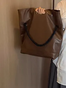 Minimalist brown soft leather tote bag with black rope handle for women autumn commute.