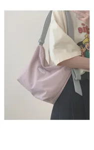 Detail view of the pink canvas hobo shoulder bag with contrast blue strap for women.