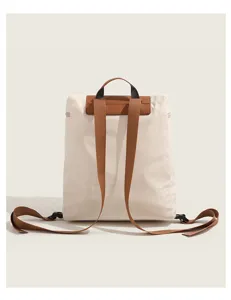 Detail view of a casual women nylon backpack in beige with brown straps, versatile daily school bag.