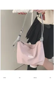Pink canvas shoulder bag for women, chic underarm bag with contrast grey strap and bow.