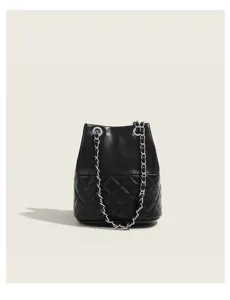 Detailed view of the black quilted bucket bag with chain strap, showing premium texture.