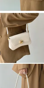 Elegant white underarm shoulder bag for women, chic baguette handbag with gold hardware.