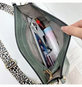 Green shoulder bucket bag interior capacity detail view showcasing spacious storage with leopard strap
