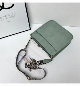 Green shoulder bucket bag with stylish leopard print wide strap for women daily use.