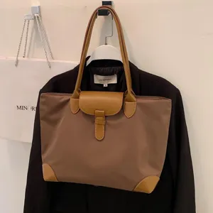 Brown large capacity commuting tote bag for women, stylish student shoulder bag for daily use.
