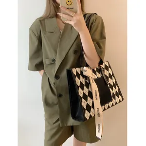Large capacity color-block tote bag for women commuting, stylish contrast design handbag.