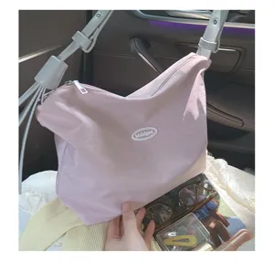 Pink canvas underarm bag detail view with white straps, casual daily shoulder bag for women