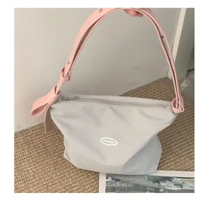 Grey canvas underarm hobo bag with pink strap casual fashion shoulder handbag detail view