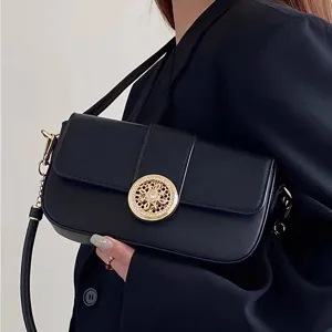 Chic black baguette shoulder bag for women with elegant gold ornate clasp and versatile strap.