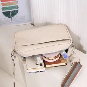 Stylish women's PU leather crossbody bag with wide strap, trendy pebble pattern casual purse.