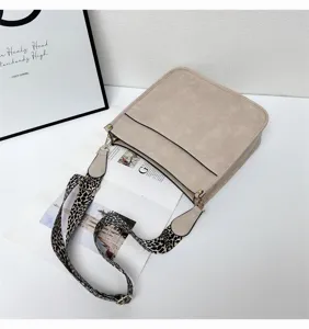Beige crossbody bucket bag for women, stylish large capacity leopard wide strap tote.