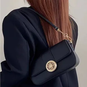 Chic black shoulder bag for women with gold hollow clasp, trendy baguette bag for daily wear.