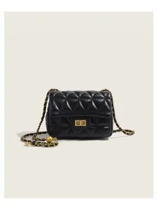 Black quilted leather crossbody bag featuring gold chain strap and metal turn lock detail.