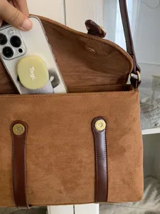 Brown suede vintage messenger bag detail, showing interior capacity and magnetic clasp.