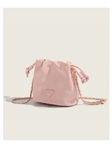 Pink bucket bag detail showing drawstring closure, metal chain strap and front logo patch.
