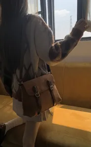 Vintage suede messenger bag for women, retro crossbody shoulder bag with double buckles.