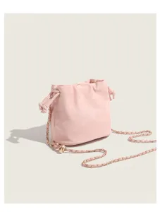 Pink bucket bag detail showing soft gathered leather texture and gold tone chain strap close up.