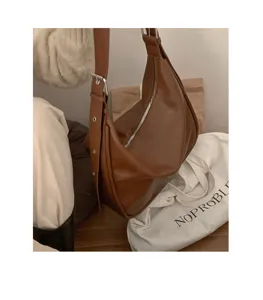 Brown leather hobo shoulder bag detail shot, showcasing soft texture and stylish wide strap.