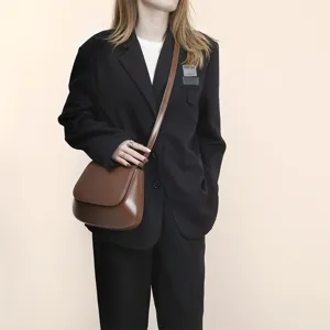 Close-up detail view of the vintage brown PU leather saddle bag, stylish everyday crossbody accessory.