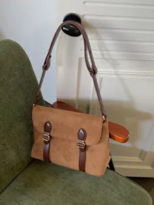 Retro brown suede messenger bag detail, vintage shoulder crossbody bag with buckle straps.