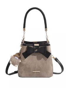 Vintage chic bucket bag with bow, black braided handle and stylish crossbody strap main view.